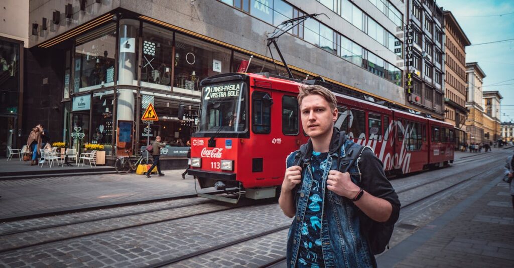 Man Standing Near Red Tram